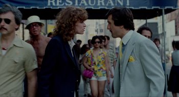 Movie still from “The King of Comedy” (1982), directed by Martin Scorsese – A man and a woman talking to each other in front of a restaurant; Medium shot, Over the shoulder angle