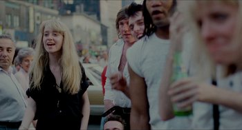 Movie still from “The King of Comedy” (1982), directed by Martin Scorsese – A group of people standing on the side of the street; Medium shot, Over the shoulder angle