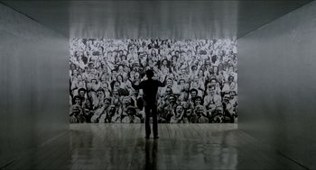 Movie still from “The King of Comedy” (1982), directed by Martin Scorsese – A man standing in front of a large picture of people; Extreme Wide shot, High angle