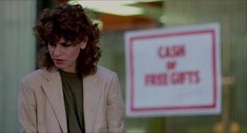 Movie still from “The King of Comedy” (1982), directed by Martin Scorsese – A woman standing in front of a cash for free gift sign; Close Up shot, Over the shoulder angle