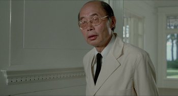 Movie still from “The King of Comedy” (1982), directed by Martin Scorsese – An older man wearing a white suit and a black tie; Close Up shot, Low angle