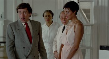 Movie still from “The King of Comedy” (1982), directed by Martin Scorsese – A group of men and women standing next to each other; Medium shot, Over the shoulder angle