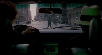 Movie still from “The King of Comedy” (1982), directed by Martin Scorsese – A view from a car of a man crossing the street; Wide shot, Over the shoulder angle