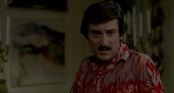 Movie still from “The King of Comedy” (1982), directed by Martin Scorsese – A person wearing a shirt; Close Up shot, Over the shoulder angle