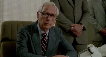 Movie still from “The King of Comedy” (1982), directed by Martin Scorsese – An older man wearing a suit and tie; Close Up shot, Low angle