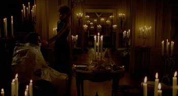 Movie still from “The King of Comedy” (1982), directed by Martin Scorsese – A woman standing in front of candles in a room; Wide shot, High angle