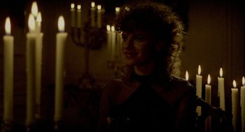 Movie still from “The King of Comedy” (1982), directed by Martin Scorsese – A woman standing in front of candles in a room; Close Up shot, Over the shoulder angle