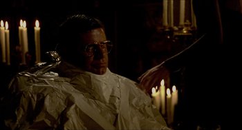 Movie still from “The King of Comedy” (1982), directed by Martin Scorsese – A man sitting in front of a lit candle in a room; Close Up shot, Over the shoulder angle