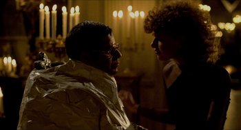 Movie still from “The King of Comedy” (1982), directed by Martin Scorsese – A man and a woman talking in front of candles in a room; Medium shot, Over the shoulder angle