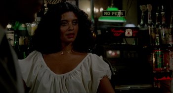 Movie still from “The King of Comedy” (1982), directed by Martin Scorsese – A woman in a white dress standing in front of a neon sign; Close Up shot, Over the shoulder angle