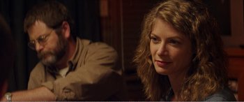 Movie still from “The Kings of Summer” (2013), directed by Jordan Vogt-Roberts – A woman sitting next to a man in a room; Close Up shot, Over the shoulder angle