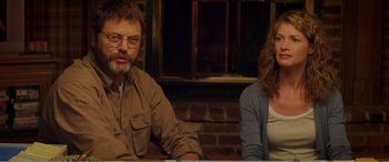 Movie still from “The Kings of Summer” (2013), directed by Jordan Vogt-Roberts – A man and a woman sitting next to each other at a table; Medium shot, Over the shoulder angle