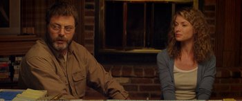 Movie still from “The Kings of Summer” (2013), directed by Jordan Vogt-Roberts – A man and a woman sitting in front of a fireplace; Medium shot, Over the shoulder angle