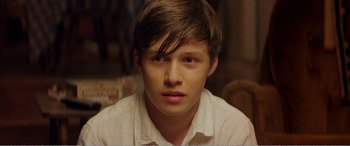 Movie still from “The Kings of Summer” (2013), directed by Jordan Vogt-Roberts – A person wearing a white shirt; Close Up shot, Over the shoulder angle