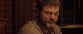 Movie still from “The Kings of Summer” (2013), directed by Jordan Vogt-Roberts – A person wearing glasses and a brown shirt; Close Up shot, Over the shoulder angle