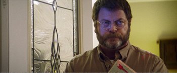 Movie still from “The Kings of Summer” (2013), directed by Jordan Vogt-Roberts – A person wearing glasses and holding a book; Close Up shot, Low angle