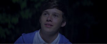 Movie still from “The Kings of Summer” (2013), directed by Jordan Vogt-Roberts – A young man looking up into the sky; Close Up shot, Over the shoulder angle
