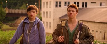 Movie still from “The Kings of Summer” (2013), directed by Jordan Vogt-Roberts – Two young men are walking in a park; Medium shot, Low angle