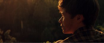 Movie still from “The Kings of Summer” (2013), directed by Jordan Vogt-Roberts – A person's face in the sunlight; Close Up shot, Over the shoulder angle