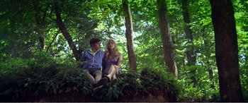 Movie still from “The Kings of Summer” (2013), directed by Jordan Vogt-Roberts – A man and a woman sitting on a tree branch; Wide shot, Low angle