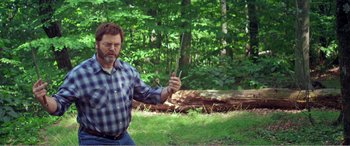 Movie still from “The Kings of Summer” (2013), directed by Jordan Vogt-Roberts – A man holding a pair of scissors in his hand; Medium shot, Over the shoulder angle