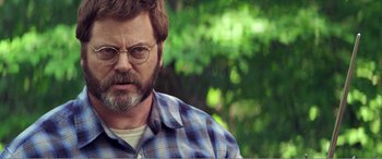 Movie still from “The Kings of Summer” (2013), directed by Jordan Vogt-Roberts – A person wearing glasses and a plaid shirt; Close Up shot, Over the shoulder angle