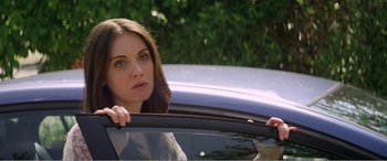 Movie still from “The Kings of Summer” (2013), directed by Jordan Vogt-Roberts – A woman sitting in the drivers seat of a car; Close Up shot, Over the shoulder angle