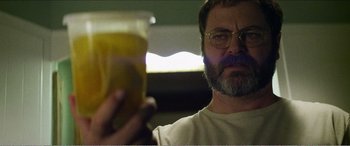 Movie still from “The Kings of Summer” (2013), directed by Jordan Vogt-Roberts – A person holding a glass of orange juice; Close Up shot, Low angle