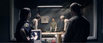 Movie still from “The Kings of Summer” (2013), directed by Jordan Vogt-Roberts – A group of people standing around a table; Wide shot, Over the shoulder angle