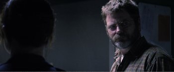 Movie still from “The Kings of Summer” (2013), directed by Jordan Vogt-Roberts – A man with a beard and glasses talking to a woman; Close Up shot, Over the shoulder angle