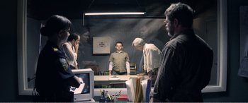 Movie still from “The Kings of Summer” (2013), directed by Jordan Vogt-Roberts – A group of people standing around a table; Wide shot, Over the shoulder angle