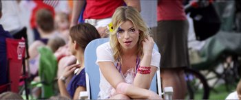 Movie still from “The Kings of Summer” (2013), directed by Jordan Vogt-Roberts – A woman sitting on a chair with a flower in her hair; Close Up shot, Low angle