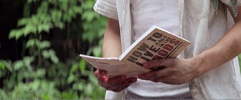 Movie still from “The Kings of Summer” (2013), directed by Jordan Vogt-Roberts – A person holding an open book in their hands; Extreme Close Up shot, High angle