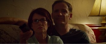 Movie still from “The Kings of Summer” (2013), directed by Jordan Vogt-Roberts – A man and a woman posing for a picture; Close Up shot, Low angle