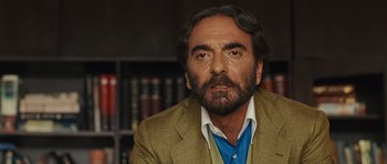 Movie still from “The Kite Runner” (2007), directed by Marc Forster – A person wearing a suit and tie; Close Up shot, Low angle