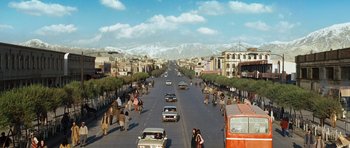 Movie still from “The Kite Runner” (2007), directed by Marc Forster – A street scene with cars driving down the road; Extreme Wide shot, High angle
