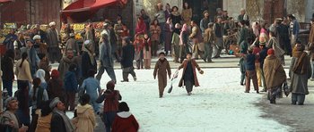 Movie still from “The Kite Runner” (2007), directed by Marc Forster – A group of people standing in the snow; Wide shot, High angle