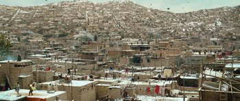 Movie still from “The Kite Runner” (2007), directed by Marc Forster – A view of a large city with a lot of buildings; Extreme Wide shot, High angle