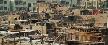 Movie still from “The Kite Runner” (2007), directed by Marc Forster – A group of people standing on top of a pile of rubble; Extreme Wide shot, High angle