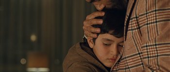 Movie still from “The Kite Runner” (2007), directed by Marc Forster – A man touching the head of a young boy; Close Up shot, Over the shoulder angle