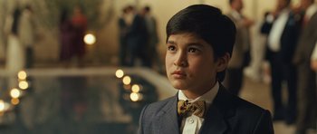 Movie still from “The Kite Runner” (2007), directed by Marc Forster – A young man in a suit and bow tie; Close Up shot, Over the shoulder angle