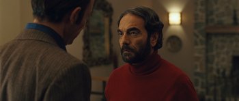 Movie still from “The Kite Runner” (2007), directed by Marc Forster – A man in a red shirt is looking at another man in a red shirt; Close Up shot, Over the shoulder angle