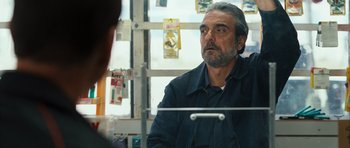 Movie still from “The Kite Runner” (2007), directed by Marc Forster – A man sitting in front of a window looking into the distance; Close Up shot, Over the shoulder angle