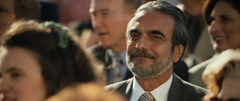Movie still from “The Kite Runner” (2007), directed by Marc Forster – A person wearing a suit and tie; Close Up shot, Over the shoulder angle