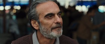 Movie still from “The Kite Runner” (2007), directed by Marc Forster – An older man with grey hair and a gray beard; Close Up shot, Low angle