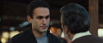 Movie still from “The Kite Runner” (2007), directed by Marc Forster – A man in a black jacket talking to another man in a black jacket; Close Up shot, Over the shoulder angle