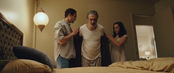 Movie still from “The Kite Runner” (2007), directed by Marc Forster – Two men and a woman standing in front of a bed; Medium shot, Low angle