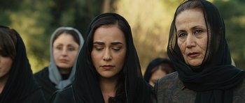 Movie still from “The Kite Runner” (2007), directed by Marc Forster – A woman with a black veil on her head; Close Up shot, Over the shoulder angle