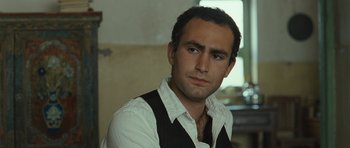 Movie still from “The Kite Runner” (2007), directed by Marc Forster – A person wearing a shirt and tie; Close Up shot, High angle