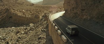 Movie still from “The Kite Runner” (2007), directed by Marc Forster – A truck driving down the side of a mountain road; Extreme Wide shot, High angle